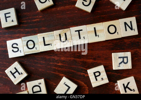 Word solution from wooden blocks with letters. Stock Photo
