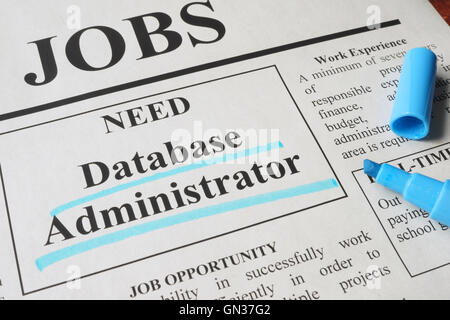Newspaper with ads for vacancy database administrator. Employment concept. Stock Photo