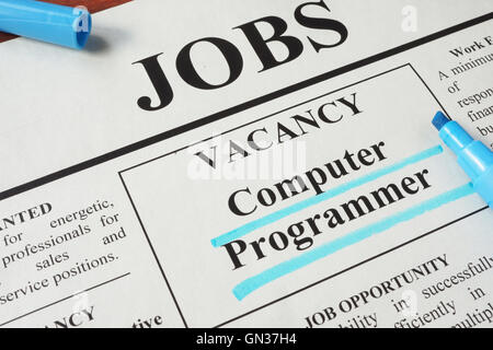 Newspaper with ads for vacancy Computer Programmer. Employment concept. Stock Photo