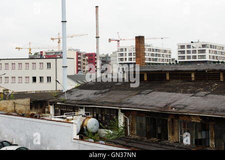 Krakow, Poland - August 11, 2016: Podgorze, old industrial district of Krakow. In the background  new buildings and cranes Stock Photo