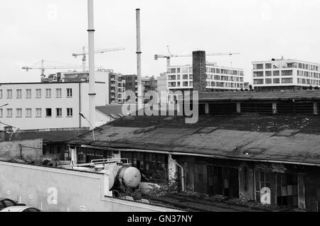 Krakow, Poland - August 11, 2016: Podgorze, old industrial district of Krakow. In the background are new buildings and cranes Stock Photo