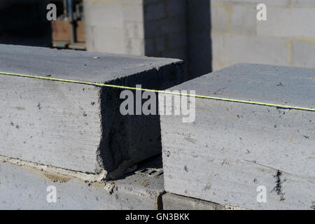 Close up of bricklayer's brick line string and bricks. Stock Photo