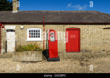 Old fashioned, vintage red petrol (gas) pump next to the Heneage Arms pub. Stock Photo