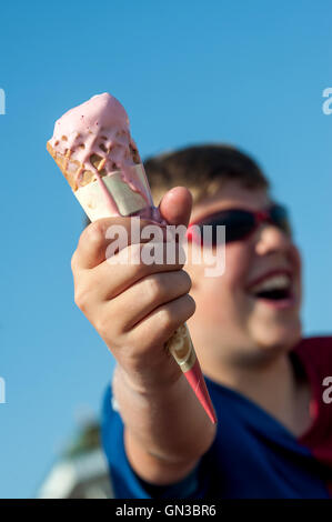 Young boys enjoying a refreshing ice-cream cone. Stock Photo