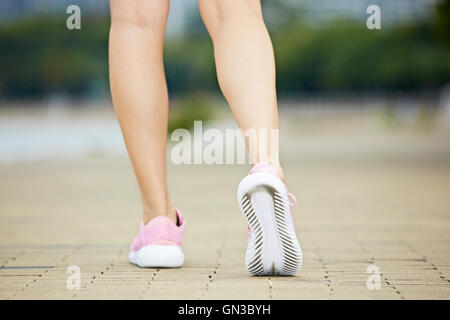 feet and lower legs of a female jogger, ready to run. Stock Photo