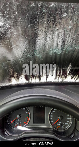 Car wash experience  with a view from inside a vehicle during cleaning process Stock Photo