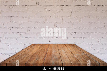 Perspective wooden table top with brick wall decorated in coffee shop Stock Photo