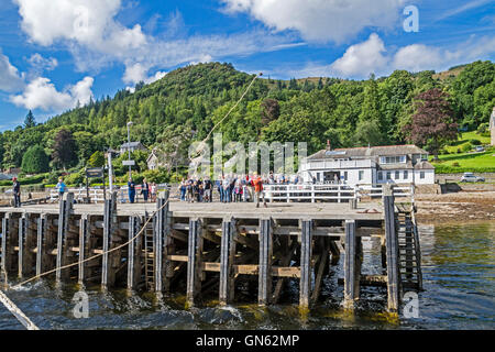 The pier with passengers for Waverley at coastal village of Tighnabruaich seen from the Kyles of Bute in Argyll & Bute Scotland Stock Photo