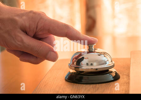 Guest ringing the service bell for assistance Stock Photo