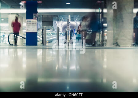 Fast people on escalators in a station Stock Photo