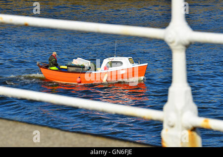 Boat entering Whitby harbour North Yorkshire England UK Stock Photo