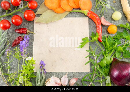 Paper for writing recipe surrounded by fresh vegetables Stock Photo