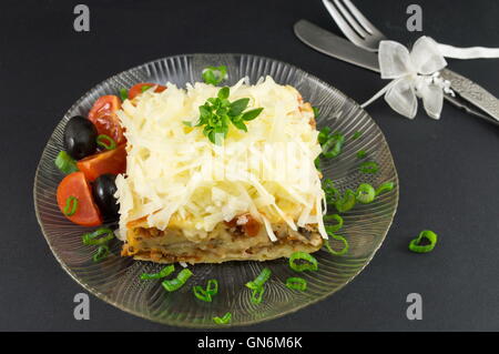 Black plate with delicious lasagna on white background Stock Photo - Alamy