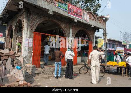 A set of small stalls selling marigold garlands next to a village market on the main street in Agra, Uttar Pradesh.India Stock Photo