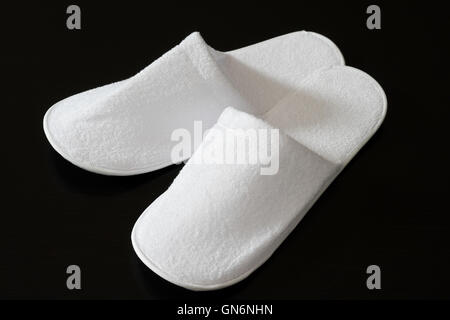 Spa slippers white on a black background Stock Photo