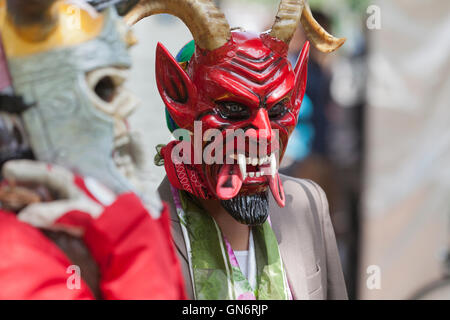 Mexican traditional fold dancer wearing devil's mask Stock Photo
