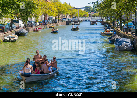 People enjoying and relaxing on boats on Oudegracht canal in Alkmaar, North Holland, Netherlands Stock Photo