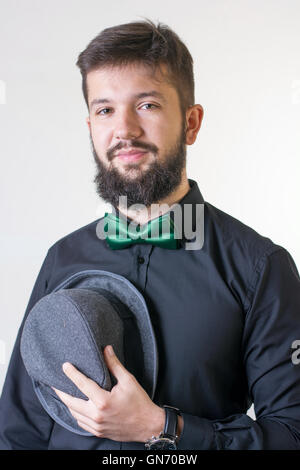 Fashionable man in a black shirt with a bow tie Stock Photo