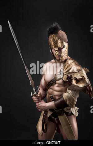 Severe barbarian in leather costume with sword Stock Photo