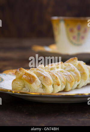 Homemade danish puff pastry braid with vanilla pastry cream, melted chocolate and chocolate chips drops Stock Photo