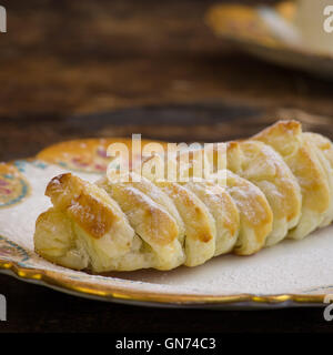 Homemade danish puff pastry braid with vanilla pastry cream, melted chocolate and chocolate chips drops Stock Photo