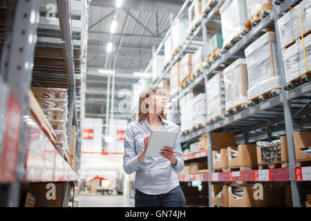 beautiful young furniture store store worker stock taking. Stock Photo