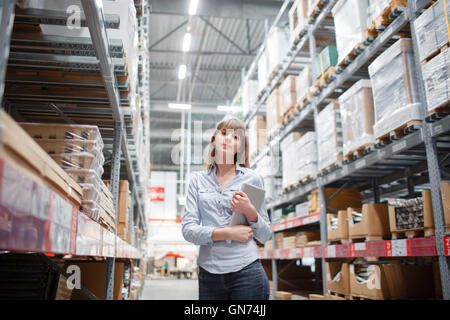 beautiful young furniture store store worker stock taking. Stock Photo