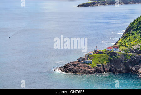 A speeding boat passing a Canadian National Historic Site, Fort Amherst in St John's Newfoundland. Stock Photo