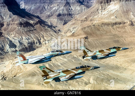 A formation of 2 F16 and one F15 Israeli Air Force fighter jets flying over the Judea mountains Dead sea area Stock Photo