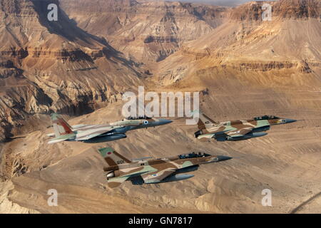 A formation of 2 F16 and one F15 Israeli Air Force fighter jets flying over the Judea mountains Dead sea area Stock Photo