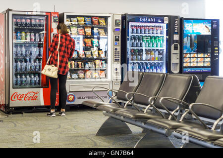Miami Florida International Airport MIA,aviation,terminal,gate,vending machine,water,soft drink drinks,soda,Coca-Cola,adult adults,woman female women, Stock Photo