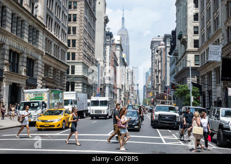 New York City,NY NYC,Manhattan,Midtown,Fifth Avenue,East 17th Street,street scene,crossing,one-way,traffic,taxi,truck,car cars,adult,adults,man men ma Stock Photo