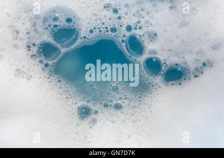 closeup to white foam on blue water Stock Photo