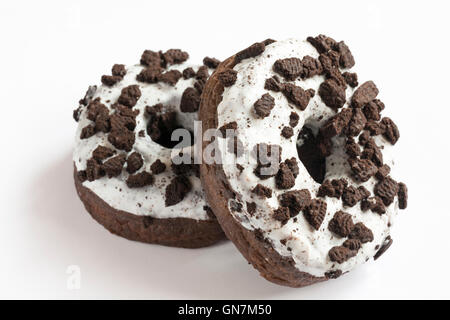 two Oreo doughnuts made with Oreo cookie pieces & with creme filling isolated on white background Stock Photo