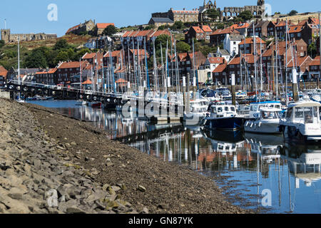 Boats in Whitby Harbour and Whitby Castle in background Stock Photo