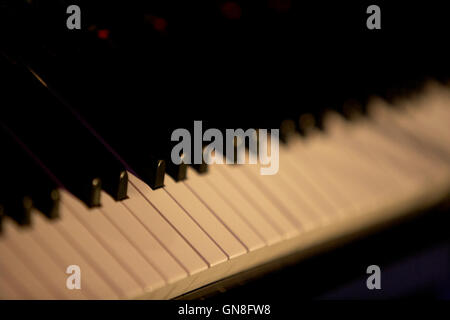 shallow depth of field on dimly lit piano keyboard Stock Photo