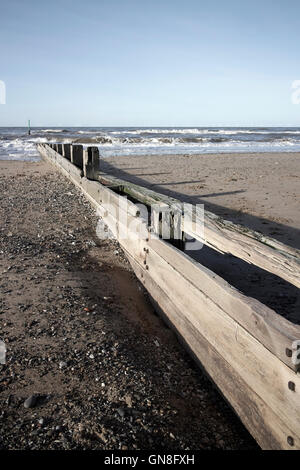 wooden groyne sea defences on the beach at rhyl north wales Stock Photo