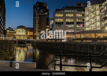 Leeds Railway Station New South Entrance in the late evening viewed across the Leeds-Liverpool canal at Granary Wharf, Leeds. Stock Photo