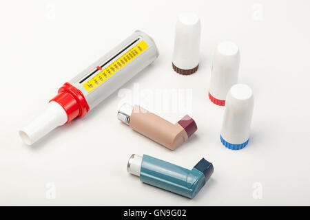 Various types of spray and powder asthma inhalers and a peek low meter on a white background Stock Photo