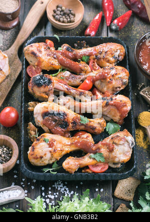 Hot and spicy drumsticks on serving pan Stock Photo