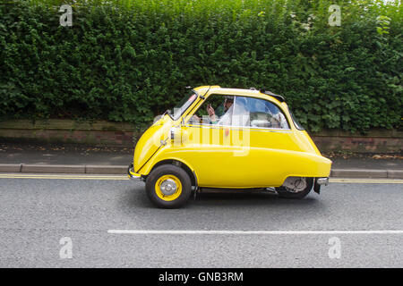 Yellow Isetta 3 wheeler, rare, egg-shaped cruiser with rounded, bubble-like windows at Ormskirk MotorFest with classic veteran bubble cars in the historic town centre, in Lancashire, UK Stock Photo