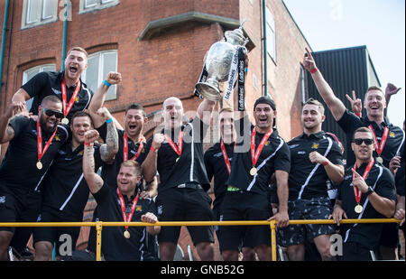 Hull FC captain Gareth Ellis (left), coach Lee Radford and Danny Houghton (right) with the Challenge Cup trophy during the open top bus tour parade through Hull City Centre. Stock Photo