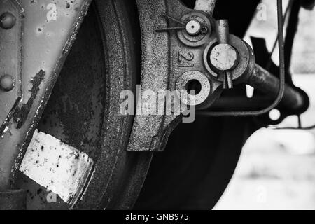 Old wheel with brake details of industrial railway carriage, stylized black and white close up photo Stock Photo