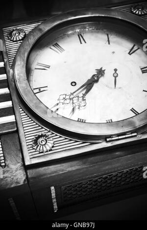 Vintage grandfather clock, decorative wooden body and white dial fragment. Close up black and white stylized photo Stock Photo