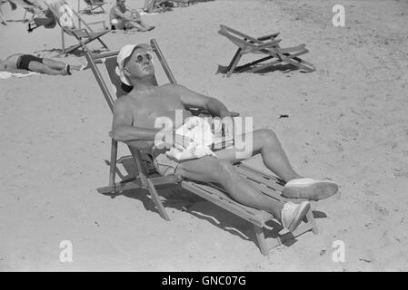 Man Sunbathing on Beach, Miami Beach, Florida, USA, Marion Post Wolcott for Farm Security Administration, March 1939 Stock Photo