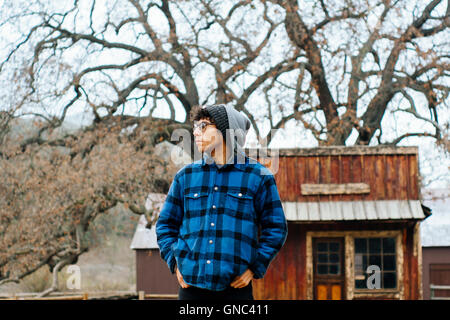 Portrait of Young Adult Man in Blue & Black Plaid Shirt at Ranch Stock Photo