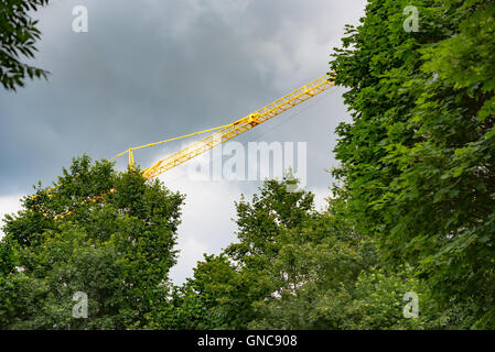yellow hoisting crane on natural background Stock Photo