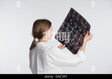 Female doctor examining an x-ray picture, back-view Stock Photo