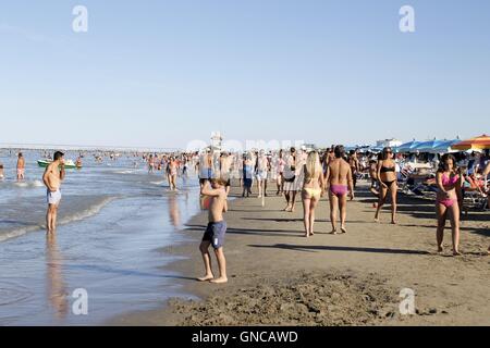 People strolling on the beach of Gatteo a mare in Romagna in Italy on Adriadico sea Stock Photo