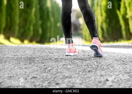Female legs in sport sneakers Stock Photo